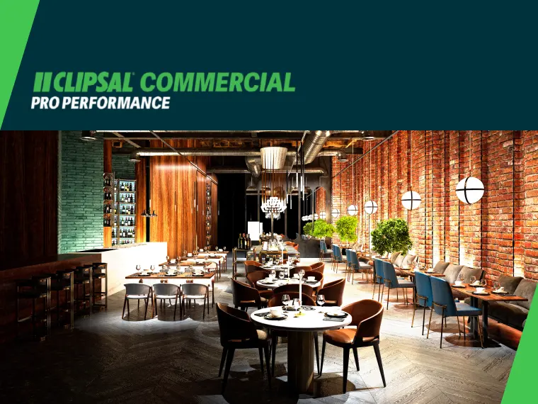 Restaurant interior with brick walls, hanging lights, and dining tables.