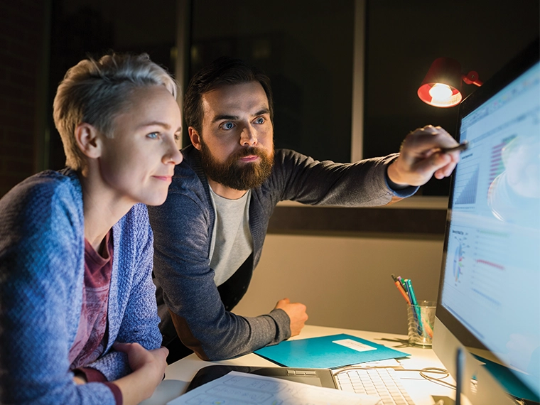 Man and woman looking at a computer screen.