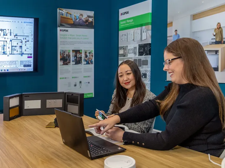 A Clipsal Design Service consultant showing Clipsal product options to a client.
