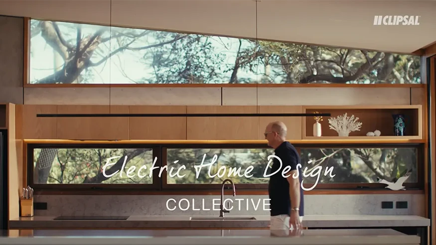 Paul Butterworth walking through a modern kitchen, overlaid with Electric Home Design Collective by Clipsal branding.