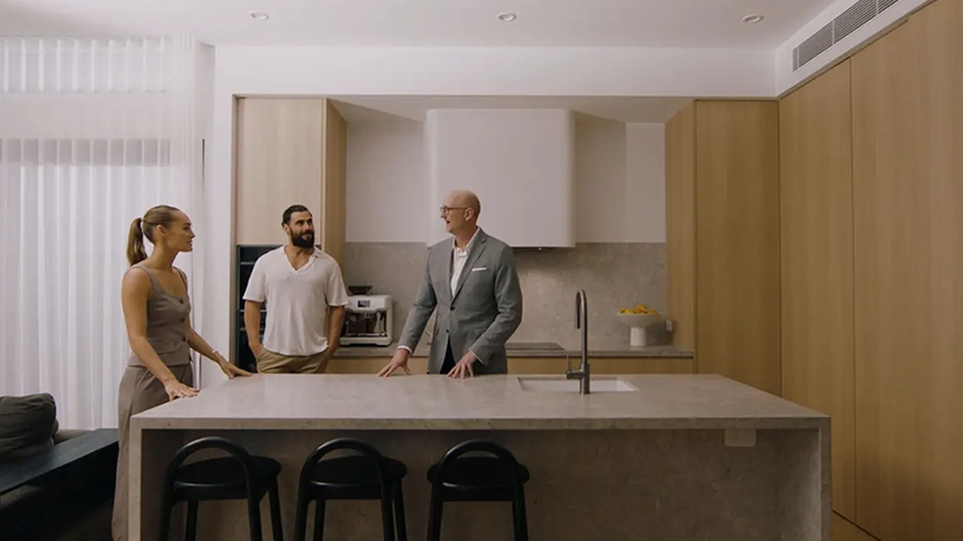 Kate, Neil, and Paul from the Electric Home Design Collective gathered in the kitchen of the Water Street House.