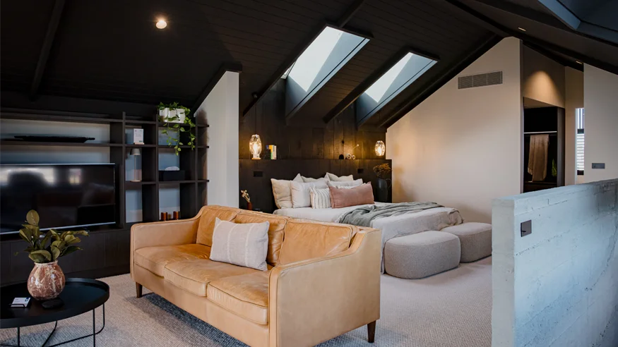 A bedroom in Design Builders’ new build by Lake Taupō, featuring Clipsal Solis switchgear.