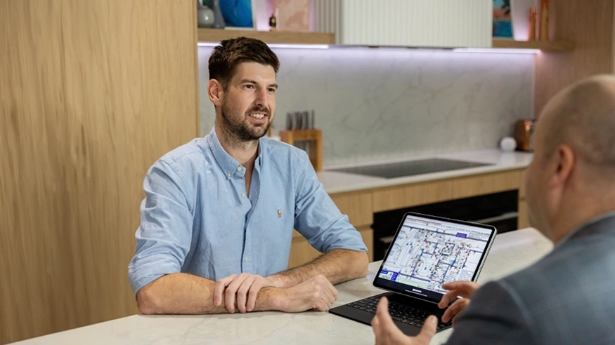 A client smiling while having a discussion with a Clipsal Design Service consultant.