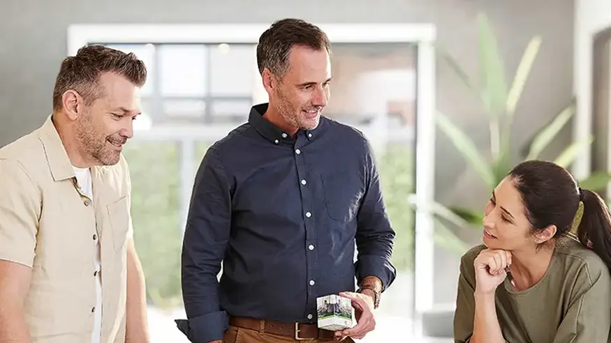 A builder showing Clipsal products to two clients.