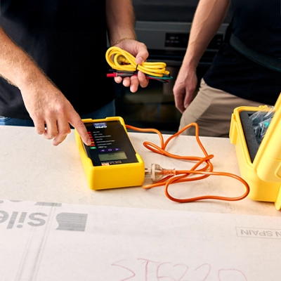 Electricians pairing a Clipsal Spark-e-mate with their mobile devices via Bluetooth.