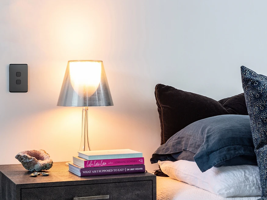 A minimalistic bedtable with a black Clipsal Iconic switch above it.