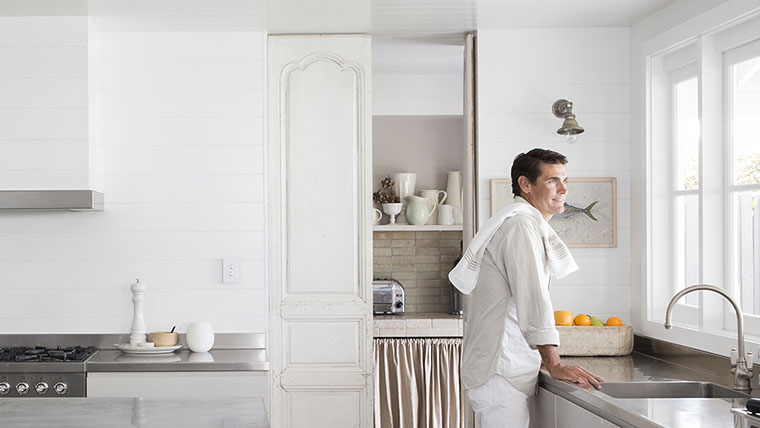 Homeowner relaxed in their kitchen with Saturn 4000 light switches