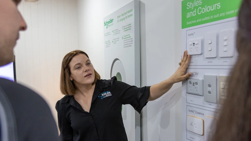 An electrician from Polar Industries talking to customers about Clipsal switches and sockets.