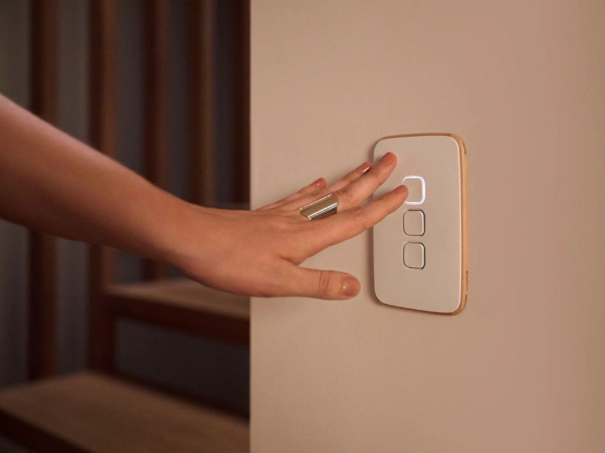 A Clipsal Iconic Essence switch in use in a residential setting.