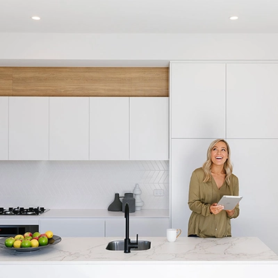 A woman looks at Clipsal's mailing list on her tablet.