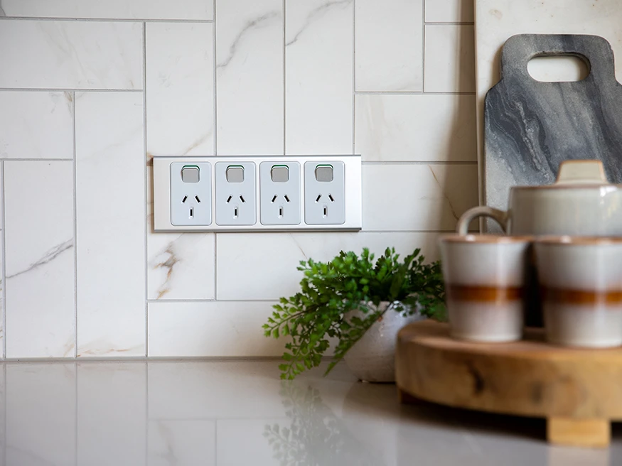 A minimalistic kitchen with a Clipsal Iconic Styl power outlet.