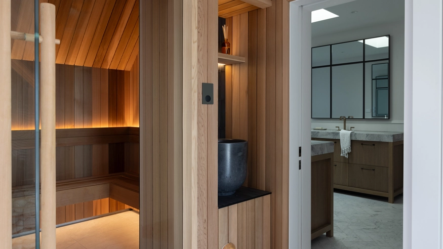 A sauna designed in the organic modernist style with Clipsal products featured.