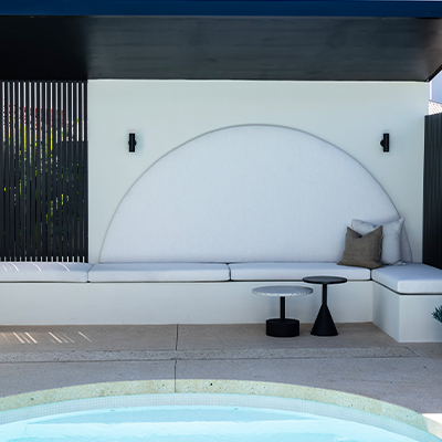 A monochrome depiction of an outdoor space with a pool, framed by trees and plants.
