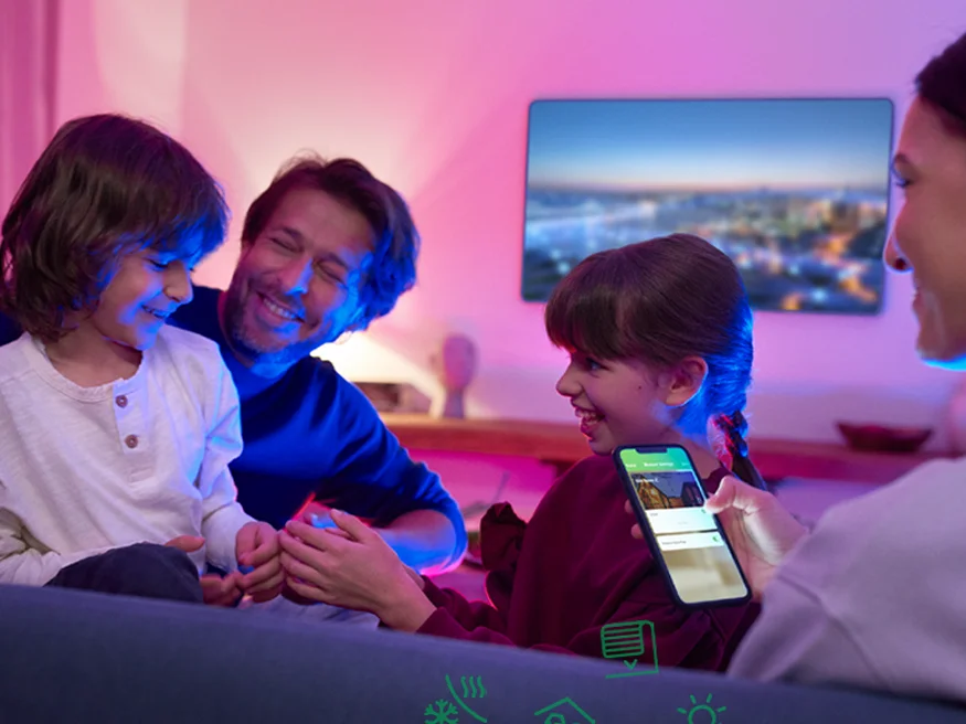 A family using the Wiser Smart Home system on their mobile devices.