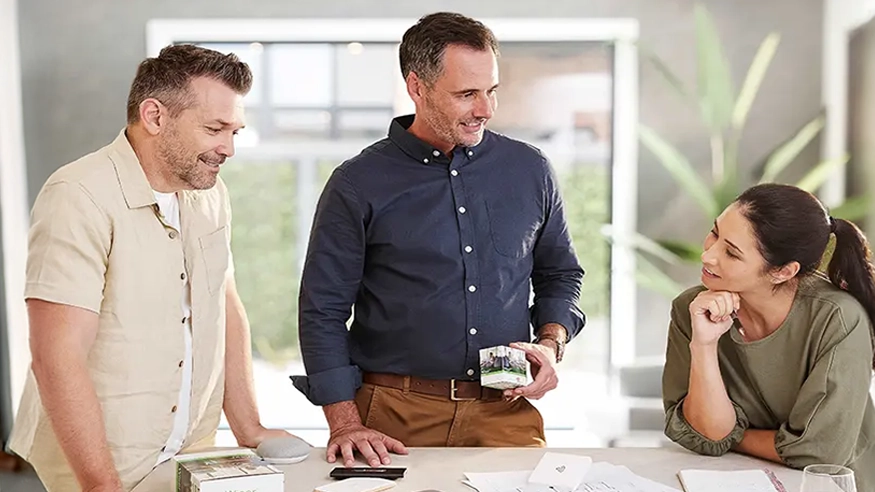 A residential builder discussing Clipsal electrical products with a pair of homeowners.
