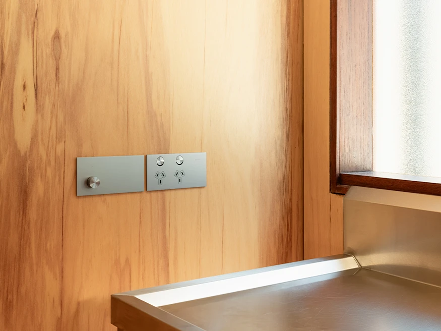 Solis T Series in Platinum Aluminium installed on a timber wall next to a window.