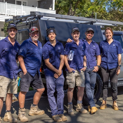 Electricians from KJN Electrical reviewing an electrical plan in a construction site.