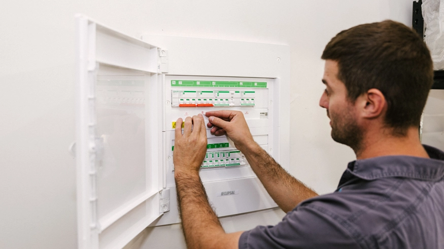 An electrician installing Clipsal MAX9 switchboards in a home.