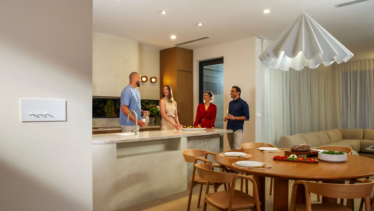 Homeowners Brad and Tess in their home with a Clipsal Solis T switch installed on a wall in the foreground.