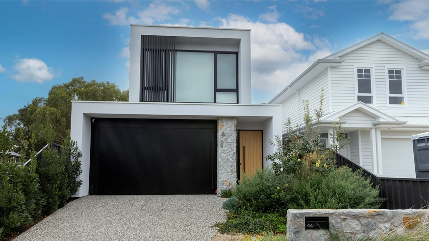 A front-exterior shot of a modern suburban home.