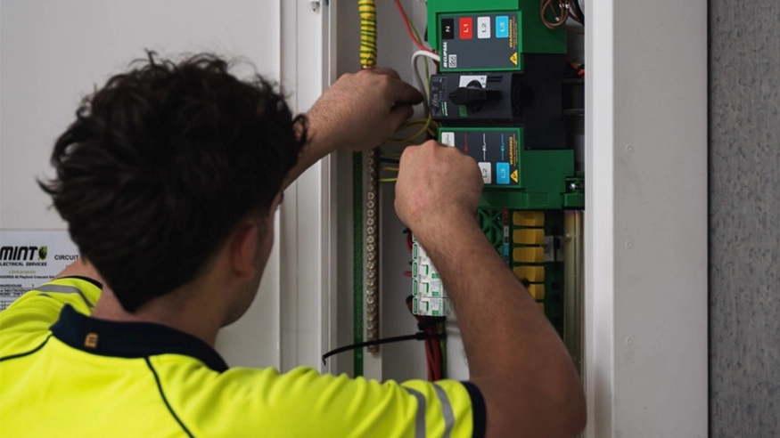 An electrician from Mint Electrical installing a MAX9 PRO distribution board.