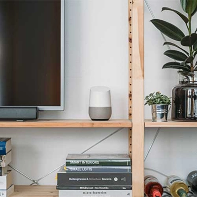 A smart appliance on a counter next to a TV.