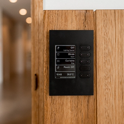 SpaceLogic C-Bus wall panel with controls for lights, blinds, curtains, and room settings.