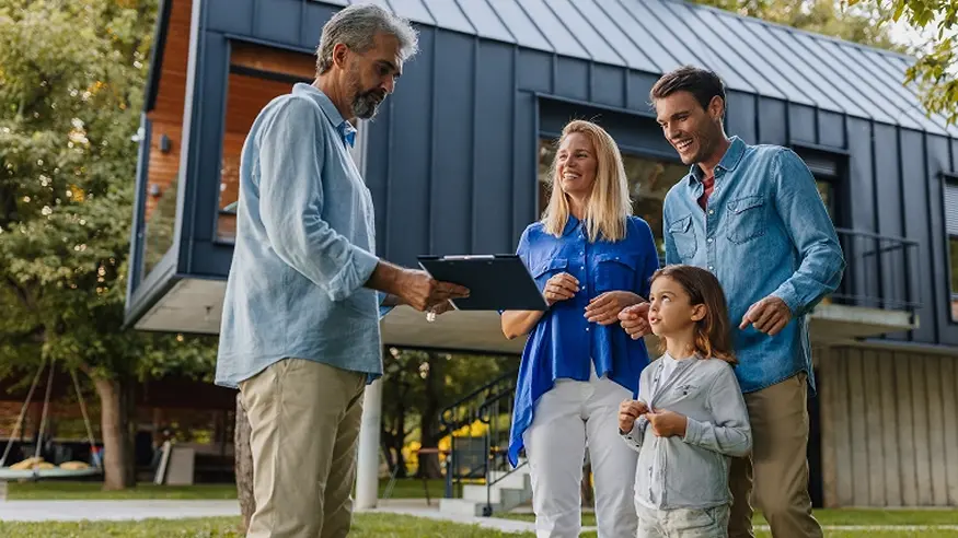 A family having a discussion in front of a home.