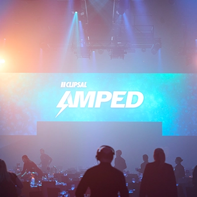 A spotlight-lit stage at the AMPED26 event.