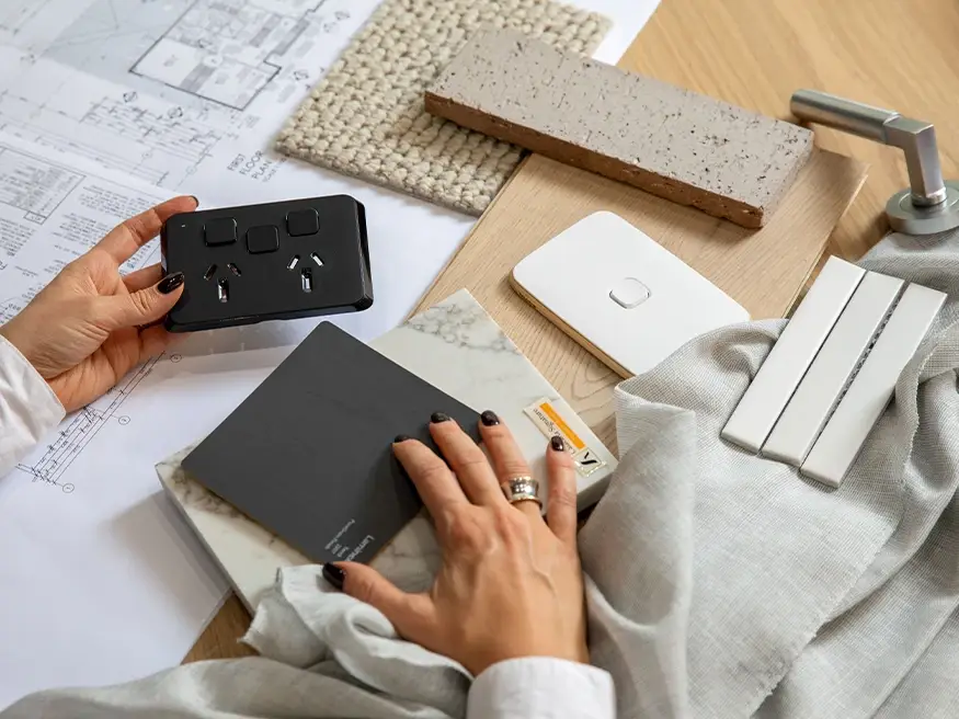 A homeowner comparing Clipsal Iconic switches.