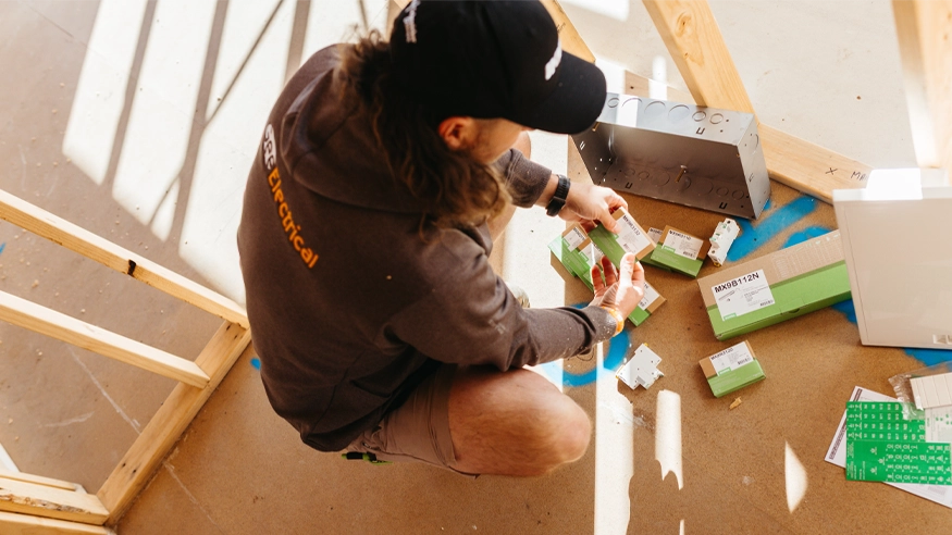 Chris Gee from Gee Electrical inspecting packages of Clipsal MAX9 products.