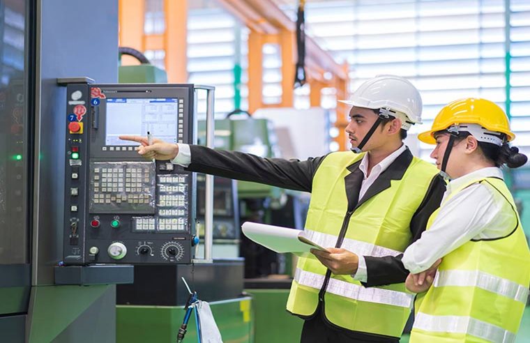 Male and Female Industrial Engineers in Hard Hats
