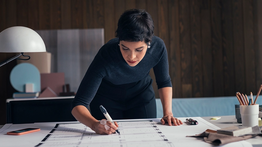 A design professional planning out a home's electrical design.