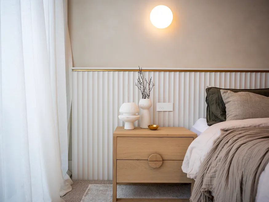 A Clipsal Solis switch in matte white installed in a bedroom.