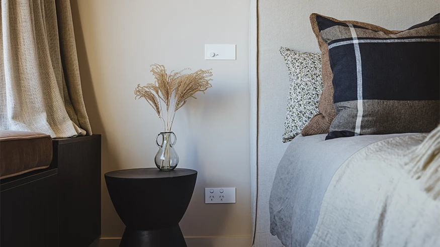 White Clipsal Solis luxury switches and power points in a bedroom.