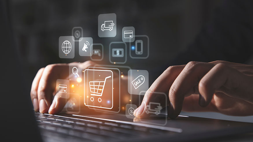 Man using laptop with shopping cart icon