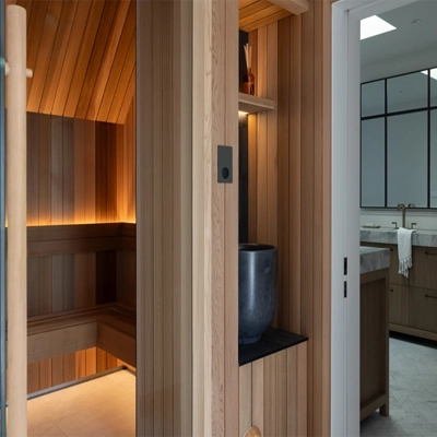 A sauna designed in the organic modernist style with Clipsal products featured.