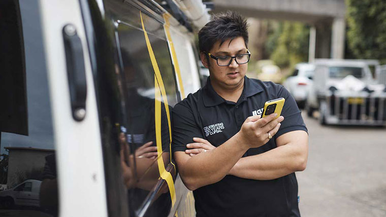 Clipsal Electrician browsing his smartphone