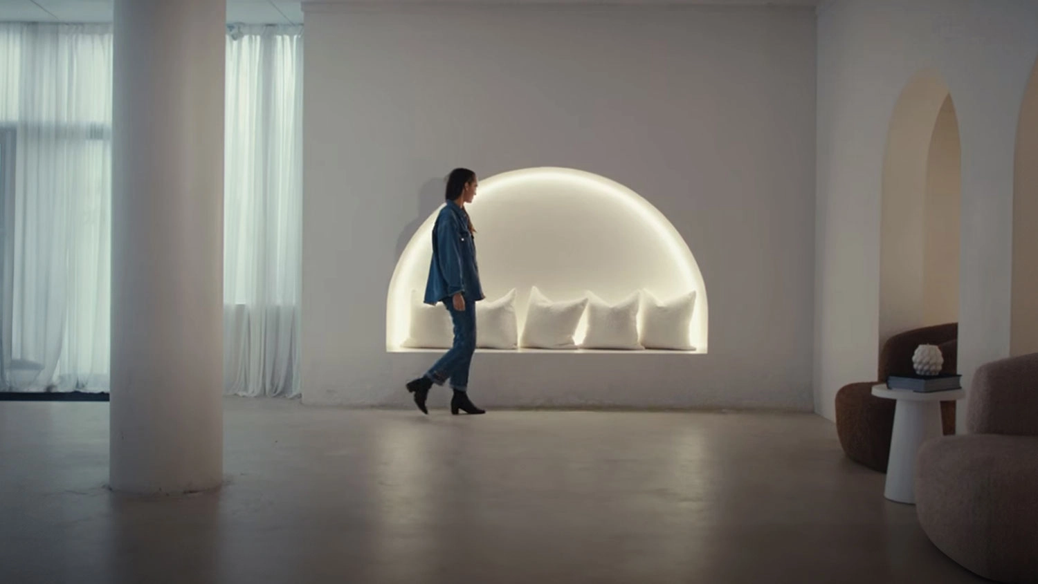 A designer from the Electric Home Design collective walking through a living room.