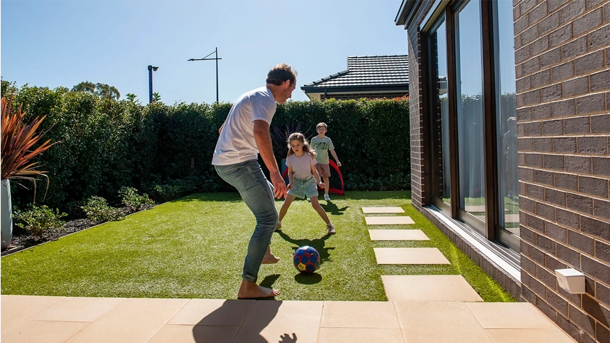 A family playing together in a yard.