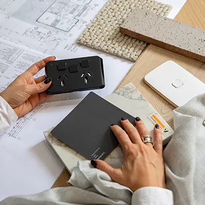 A homeowner comparing Clipsal Iconic switch and socket products.