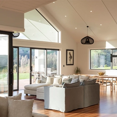 Modern living space featuring large glass sliding doors, with a bright, well-lit and relaxing atmosphere.