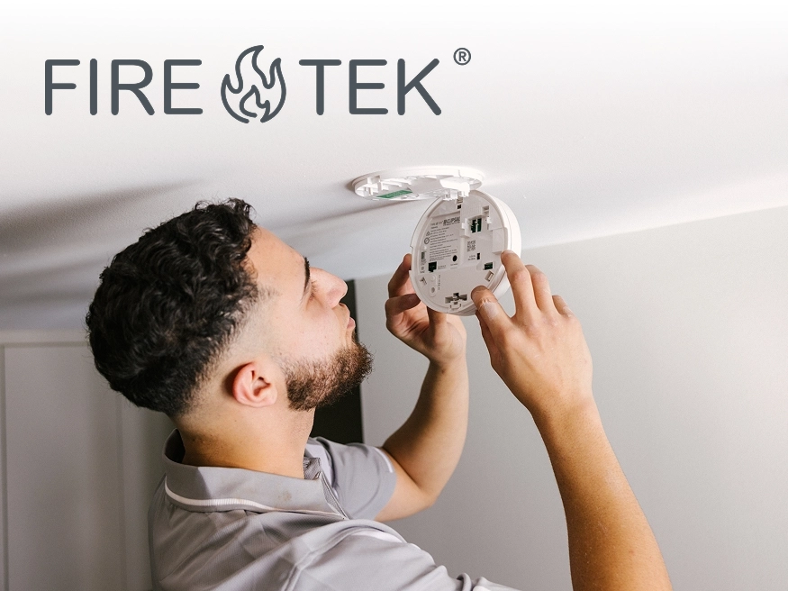 An electrician installing a Clipsal smoke alarm.