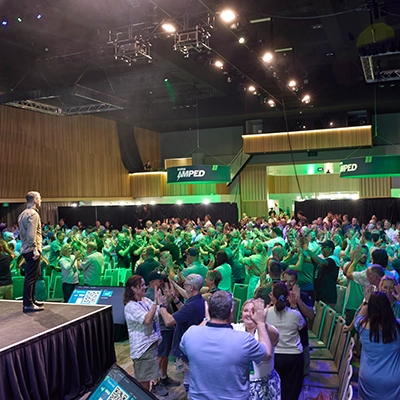 A crowded event hall in use during the AMPED26 event.