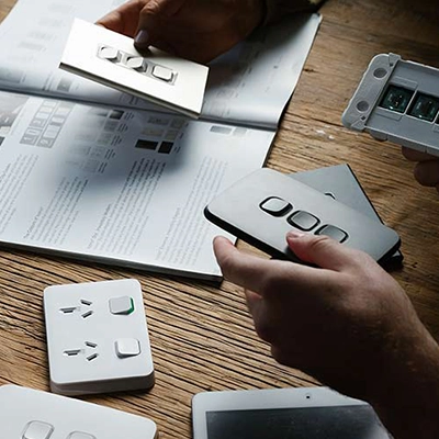 A range of Clipsal switches products laid out on a table next to an open magazine.