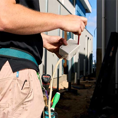 An electrician holding a Clipsal Junction Box.