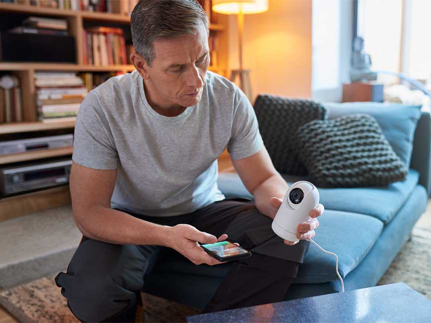 man holding wiser ip camera