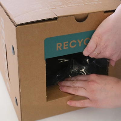 A TerraCycle Zero Waste Box with a folded lid and inserted tab.