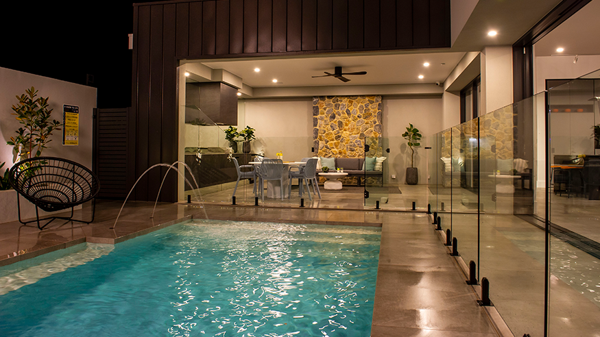 A nighttime view of a home pool, gentle lighting that enhances the calm and inviting atmosphere.
