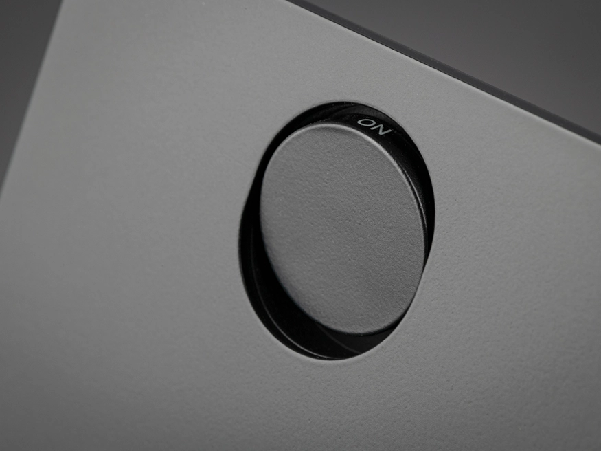 A close up of a Clipsal Solis Matte Black switch's push button, showcasing the detailing in the switch plate.
